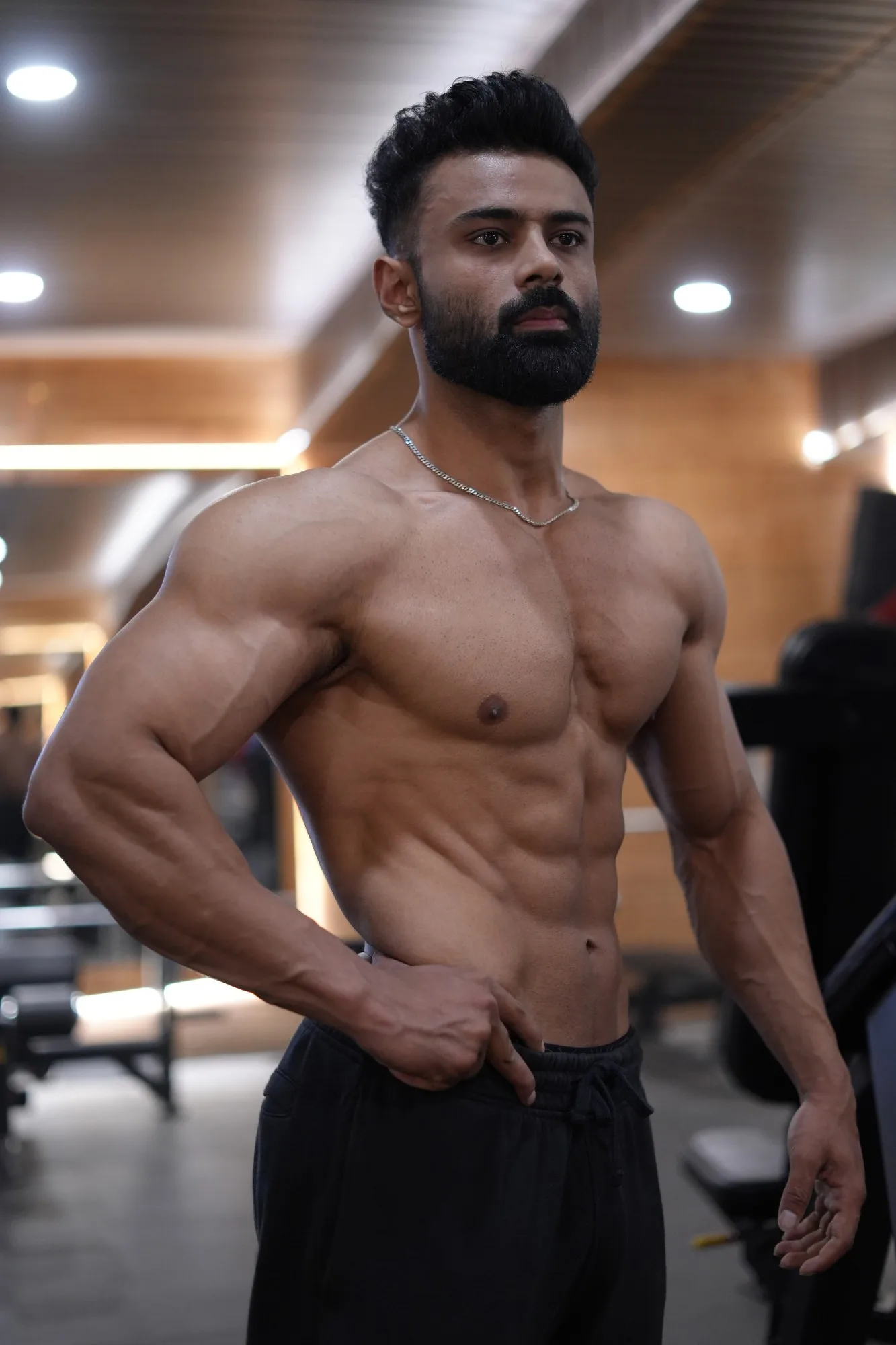 Anant, coach at The Muscular Wolfie, showing his physique in the gym